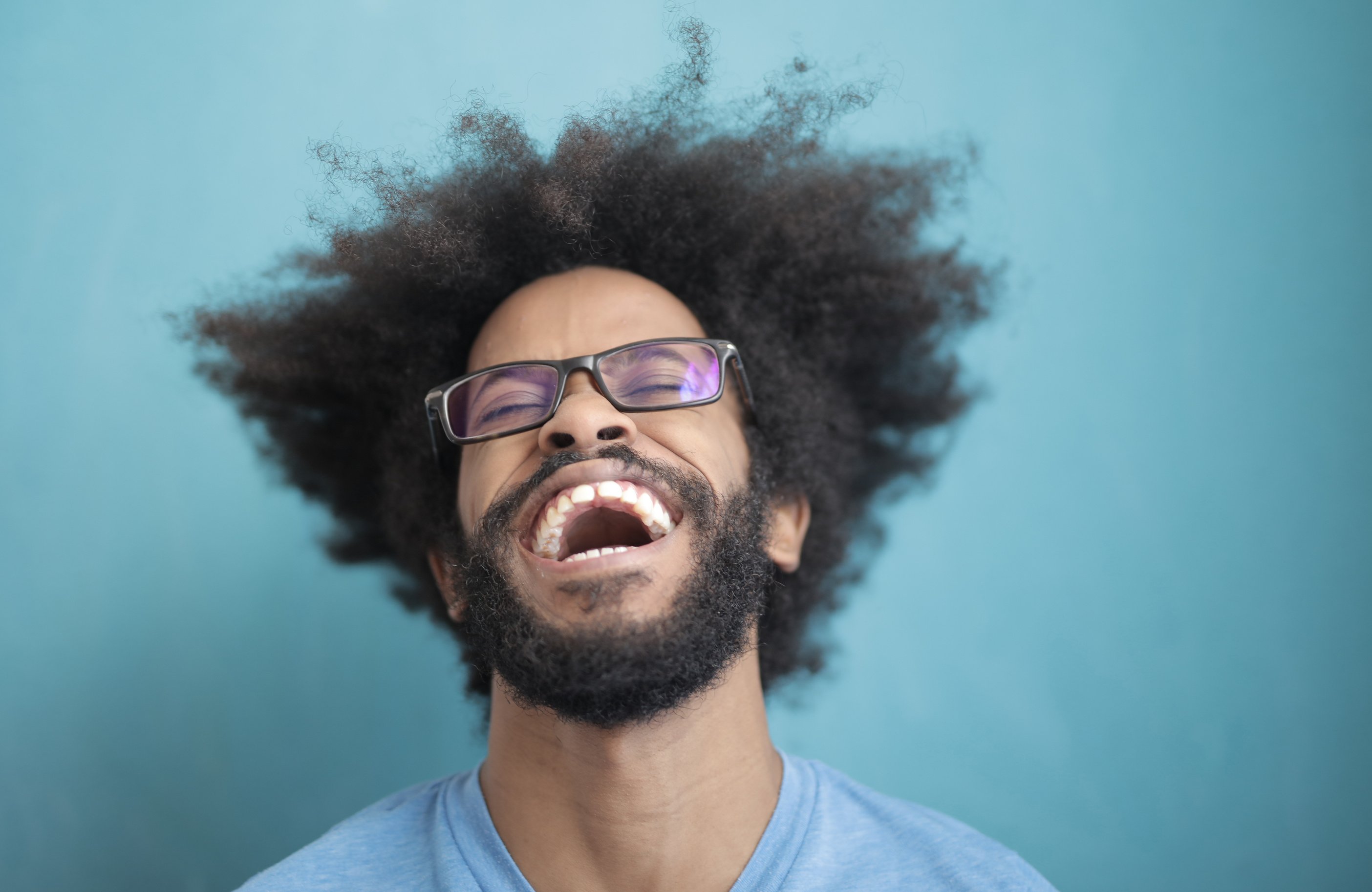 Man in Blue Crew Neck Shirt Wearing Black Framed Eyeglasses