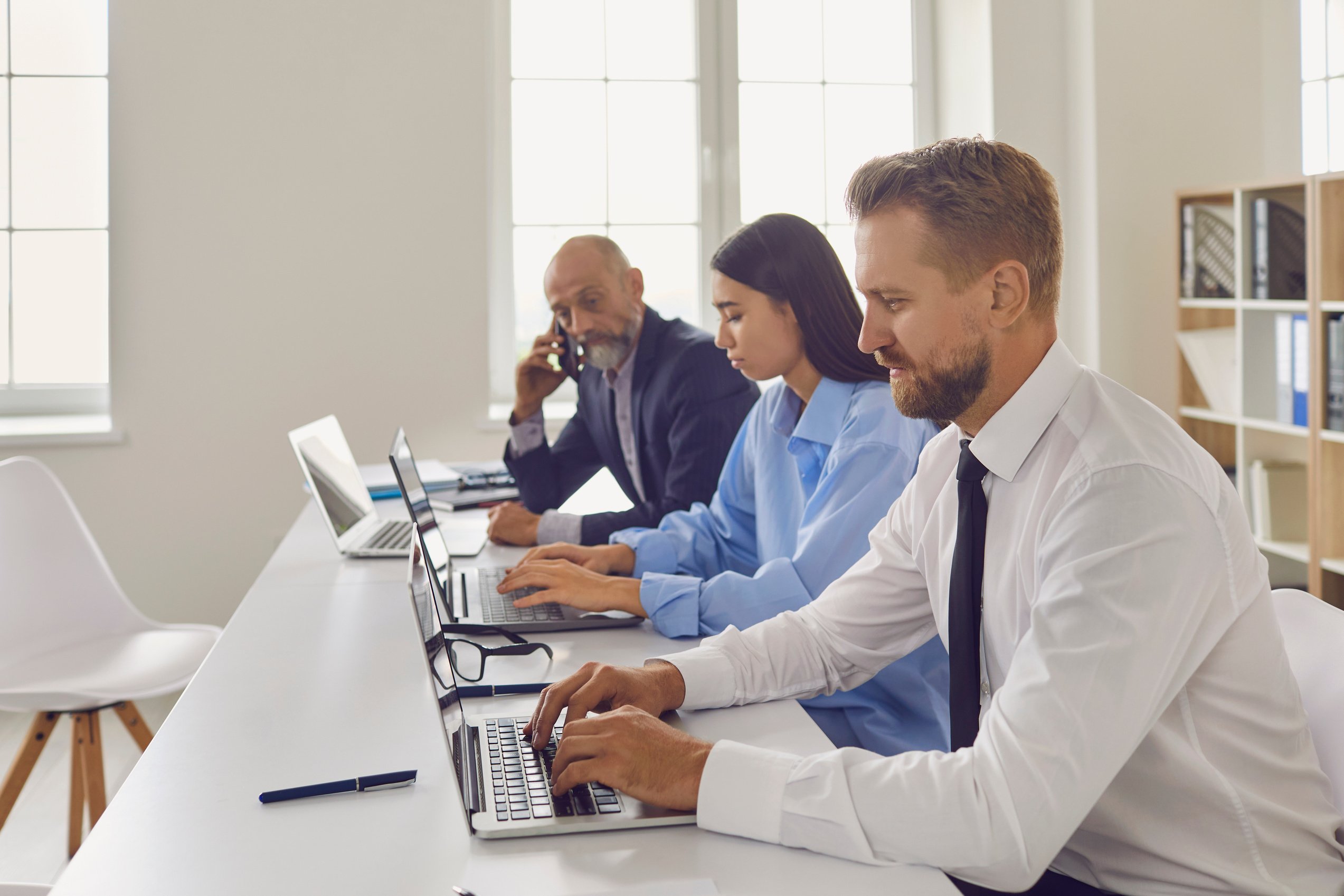 Company Employees Sitting at Office Desk, Working on Laptops, Doing Research and Collecting Data